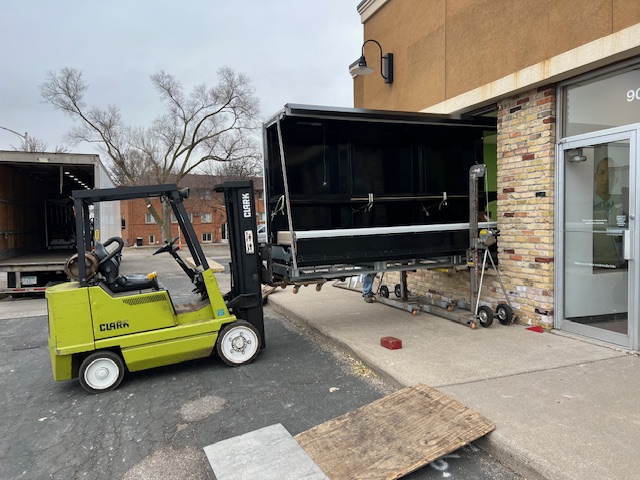 services-03 Three semi trucks driving on a highway through a forested landscape in Arizona.