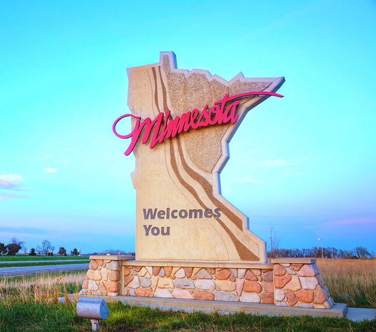services-04 Three semi trucks driving on a highway through a forested landscape in Arizona.